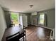 Kitchen featuring a refrigerator, stove, deck access, and wood flooring at 1025 Martin Luther King Jr Dr, Albemarle, NC 28001