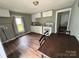 Kitchen featuring wood flooring, white cabinets, and standard appliances at 1025 Martin Luther King Jr Dr, Albemarle, NC 28001