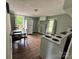 Kitchen featuring a refrigerator, stove, deck access, and wood flooring at 1025 Martin Luther King Jr Dr, Albemarle, NC 28001