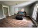 Inviting living room featuring a cozy sofa, ottoman, and wood flooring, with great natural light at 1025 Martin Luther King Jr Dr, Albemarle, NC 28001