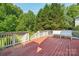 Red deck with trees and green grass in the background at 10316 Willingham Rd, Huntersville, NC 28078