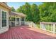 Expansive back deck features a screened-in porch and overlooks a lush green lawn with mature trees at 10316 Willingham Rd, Huntersville, NC 28078