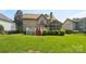 Spacious backyard with lush greenery and a deck with a screened porch, perfect for outdoor living at 10316 Willingham Rd, Huntersville, NC 28078