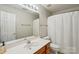 Bathroom features vanity with a large mirror, lighting and walk-in shower at 10316 Willingham Rd, Huntersville, NC 28078
