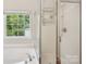 Bright bathroom features a large window, separate shower, and soaking tub at 10316 Willingham Rd, Huntersville, NC 28078