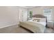 Comfortable bedroom featuring neutral tones, two windows, and a doorway into a bathroom at 10316 Willingham Rd, Huntersville, NC 28078
