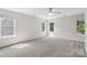 Spacious bedroom with neutral carpet, multiple windows, and a ceiling fan at 10316 Willingham Rd, Huntersville, NC 28078
