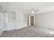 Spacious bedroom features built-in bookshelves, a ceiling fan, and ample space at 10316 Willingham Rd, Huntersville, NC 28078