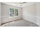 Cozy bedroom with soft carpet, natural light from windows, and neutral walls at 10316 Willingham Rd, Huntersville, NC 28078