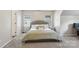 Cozy bedroom with neutral colors, plush carpeting, two windows, and comfortable furnishings at 10316 Willingham Rd, Huntersville, NC 28078
