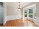 Traditional dining room with beautiful hardwood floors, classic wainscoting, and a bay window for natural light at 10316 Willingham Rd, Huntersville, NC 28078