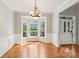 Dining room with hardwood floors, decorative light fixture, wainscoting, and a bay window with lots of light at 10316 Willingham Rd, Huntersville, NC 28078
