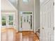 Bright foyer with hardwood floors, a staircase, and a decorative glass-paneled front door at 10316 Willingham Rd, Huntersville, NC 28078