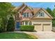 Charming two-story home with a brick facade, well-maintained lawn, and a two-car garage in a landscaped neighborhood at 10316 Willingham Rd, Huntersville, NC 28078