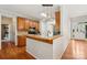 Bright kitchen showcasing wood floors, granite countertops, modern appliances, and a stylish breakfast bar area at 10316 Willingham Rd, Huntersville, NC 28078