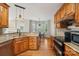 Well-lit kitchen features wooden cabinets, granite countertops, modern appliances, and access to a cozy breakfast nook at 10316 Willingham Rd, Huntersville, NC 28078
