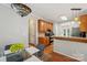 Well-appointed kitchen with wood cabinets and a decorative pendant light, next to an adjacent dining area at 10316 Willingham Rd, Huntersville, NC 28078
