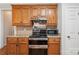 Functional kitchen with stainless steel appliances, wood cabinets, and tile backsplash for a clean and modern feel at 10316 Willingham Rd, Huntersville, NC 28078
