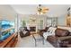 Inviting living room featuring hardwood floors, a cozy fireplace, and ample natural light from large windows at 10316 Willingham Rd, Huntersville, NC 28078