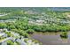 Beautiful aerial view of 11008 Round Rock Dr property nestled in a serene, tree-filled neighborhood alongside a lake at 11008 Round Rock Rd, Charlotte, NC 28277