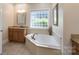 Bathroom with corner tub, tile flooring, and single vanity at 11008 Round Rock Rd, Charlotte, NC 28277