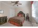 Bedroom features a ceiling fan, neutral paint and patterned bedding at 11008 Round Rock Rd, Charlotte, NC 28277