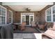 Covered patio features stone flooring, brick, ceiling fan, and outdoor seating at 11008 Round Rock Rd, Charlotte, NC 28277