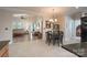 Open dining area with a chandelier and dark wood table that connects to a living room space at 11008 Round Rock Rd, Charlotte, NC 28277