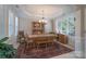 Bright dining room featuring a tray ceiling, large windows, and traditional furnishings for elegant meals at 11008 Round Rock Rd, Charlotte, NC 28277