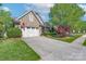 Beautiful home showcasing a stone and siding facade, two-car garage, and well-maintained landscaping at 11008 Round Rock Rd, Charlotte, NC 28277