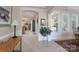 Open foyer with tile floors, arched doorways, and abundant natural light creating a welcoming ambiance at 11008 Round Rock Rd, Charlotte, NC 28277