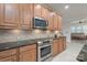 This is a kitchen with wooden cabinets, granite countertops and stainless steel appliances at 11008 Round Rock Rd, Charlotte, NC 28277