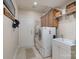 Laundry room featuring front load washer and dryer, utility sink, and storage cabinets at 11008 Round Rock Rd, Charlotte, NC 28277