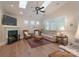 Bright living room featuring vaulted ceilings, skylights, a ceiling fan, hardwood floors, and a fireplace at 11008 Round Rock Rd, Charlotte, NC 28277