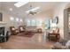 Bright living room with vaulted ceilings, skylights, hardwood floors, and a fireplace at 11008 Round Rock Rd, Charlotte, NC 28277