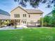 Spacious backyard with a wooden deck, pergola, and lush green lawn, perfect for outdoor entertaining at 1103 Cooper Ln, Indian Trail, NC 28079