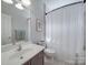Bright bathroom with a single vanity, a large mirror, and a shower-tub combination, creating a functional space at 1103 Cooper Ln, Indian Trail, NC 28079