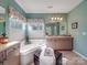 Relaxing bathroom area with a large tub, double sinks and soft green walls at 1103 Cooper Ln, Indian Trail, NC 28079
