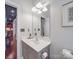 Well-lit bathroom with a vanity and a large mirror, offering a clean and modern look with neutral colors at 1103 Cooper Ln, Indian Trail, NC 28079