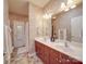 Well-lit bathroom features double sinks, modern fixtures, and a separate shower area at 1103 Cooper Ln, Indian Trail, NC 28079