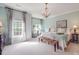 Bright bedroom with large windows, chandelier, and neutral decor at 1103 Cooper Ln, Indian Trail, NC 28079