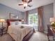 Serene bedroom with a ceiling fan, large window, and neutral decor, perfect for relaxation and rest at 1103 Cooper Ln, Indian Trail, NC 28079