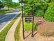 Signage for Cooper Ridge in a neighborhood with a sidewalk, street lights, and mature landscaping at 1103 Cooper Ln, Indian Trail, NC 28079