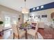 Cozy dining area adjacent to living area, featuring hardwood floors and views of the yard at 1103 Cooper Ln, Indian Trail, NC 28079