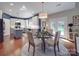 Bright dining area featuring a glass table set, hardwood floors, and white and blue walls at 1103 Cooper Ln, Indian Trail, NC 28079