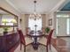 Elegant dining room with hardwood floors, chandelier, and a table set for a formal meal at 1103 Cooper Ln, Indian Trail, NC 28079