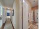 Hallway leads to a bathroom and multiple rooms; carpeted runner on hardwood floors at 1103 Cooper Ln, Indian Trail, NC 28079