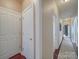 Hallway with hardwood floors, neutral paint, and white doors leading to various rooms at 1103 Cooper Ln, Indian Trail, NC 28079