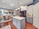 Spacious kitchen with white and gray cabinets, an island, hardwood floors, and modern appliances at 1103 Cooper Ln, Indian Trail, NC 28079