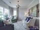 Cozy living room with comfortable seating, soft lighting, and elegant decor with neutral color palette at 1103 Cooper Ln, Indian Trail, NC 28079